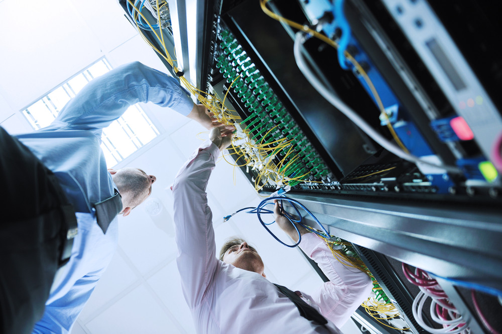 Engineers in Network Server Room Solving Problems